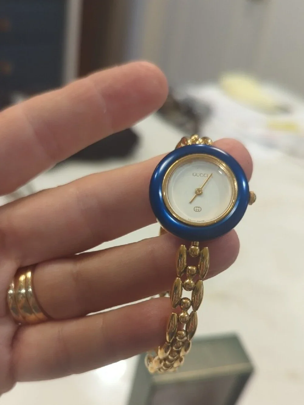 Gucci Gold Bracelet Watch with Blue Bezel and Multi-Color Interchangeable Bezels